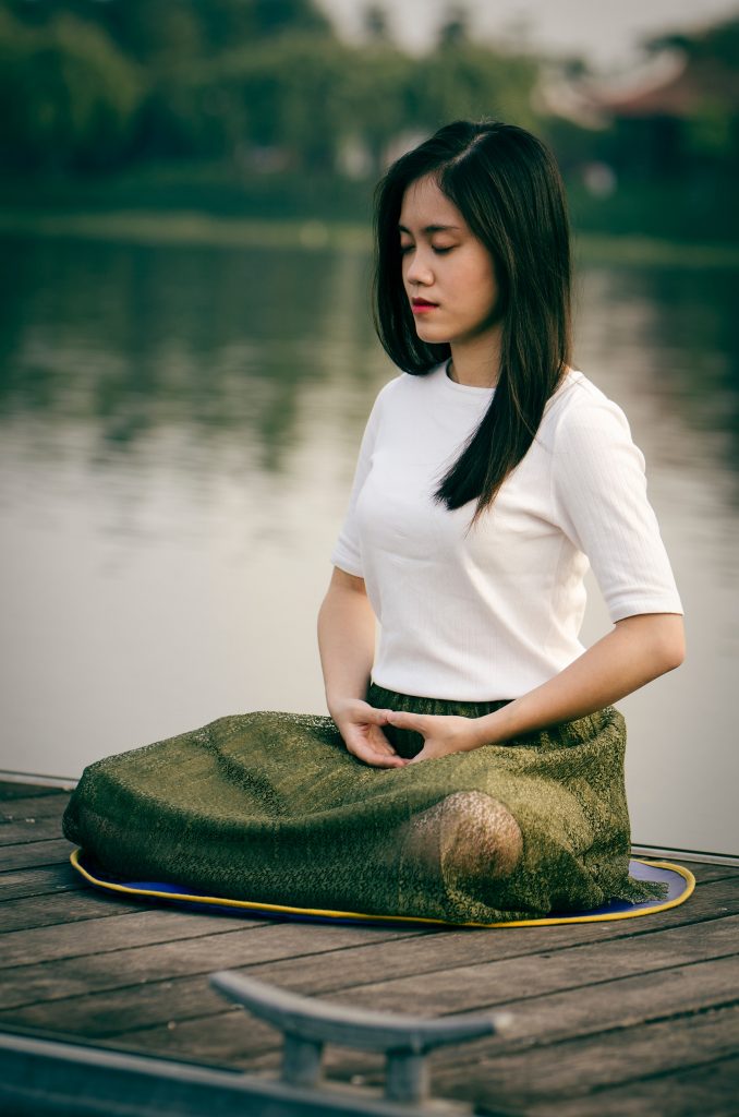 Woman in a meditation pose: self care challenges