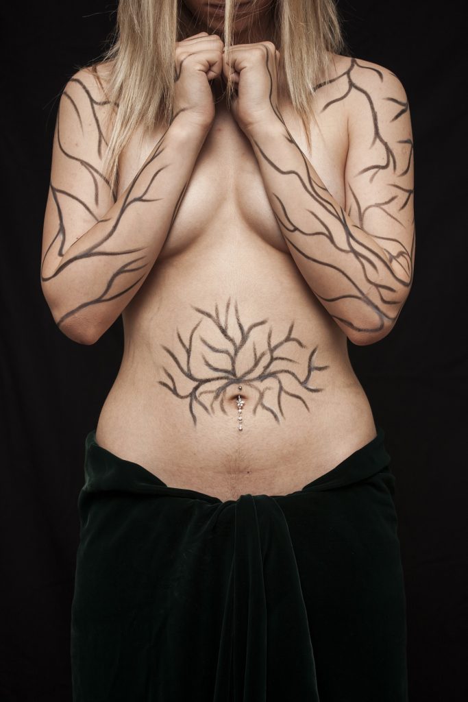Body of a tattooed woman depicting body shaming