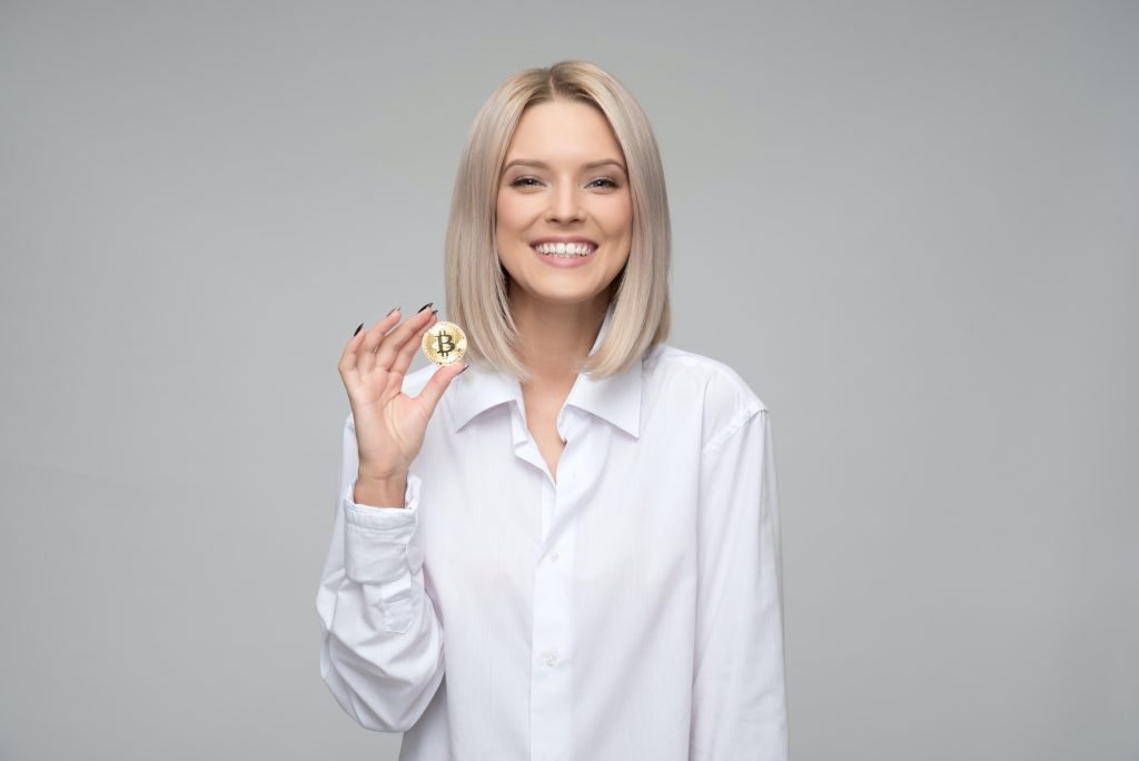 Smiling woman holding a coin