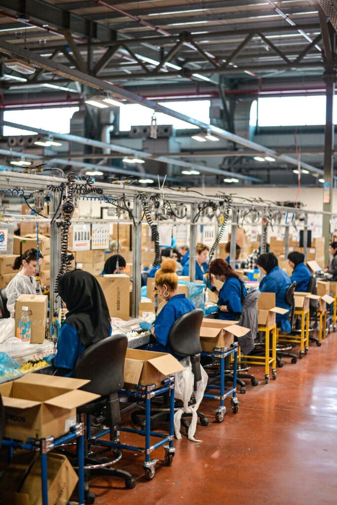 women sitting and working in a manufacturing plant